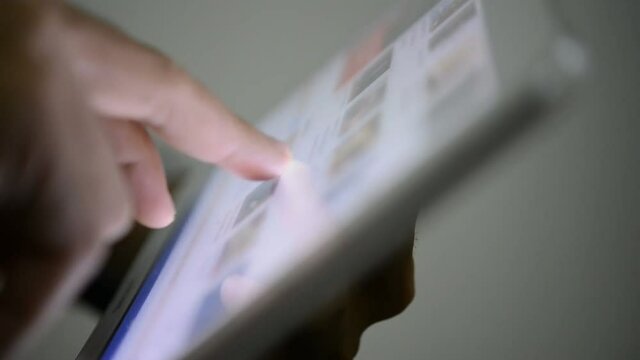 Close up, finger use tablet.