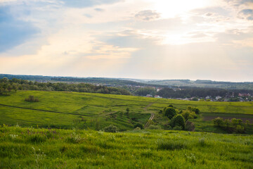 Summer or spring landscape with green hills or mountains and trees