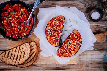 bruschetta with baked beans in tomato sauce with rosemary