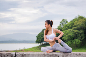 Naklejka na ściany i meble Asia woman doing yoga fitness exercise