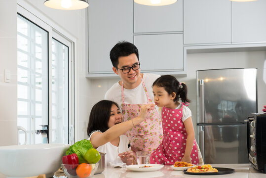 Asian Family Cooking At Kitchen