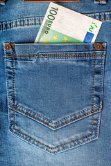100 euro note in a blue jeans pocket