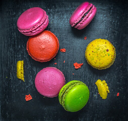 Colorful macaroons. Sweet macarons on dark background .Top view.