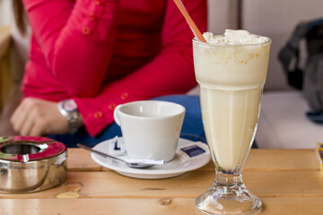 Young woman drinking coffee and milk shake  at the restaurant