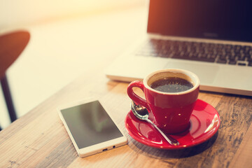 laptop and black coffe in vintage tone