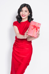 Pretty young glamorous asian woman dressed in red dress with a present