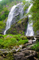 KHLONG LAN, THAILAND - August, 2016:  Jungle landscape with flowing water of Khlong Lan waterfall in Kamphaeng Phet province at deep tropical rain forest. Khlong Lan National Park, Thailand