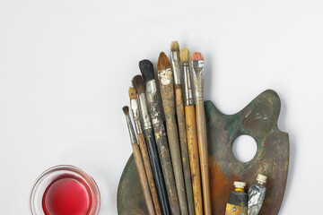 Brushes, palette, tubes with paint and solvent