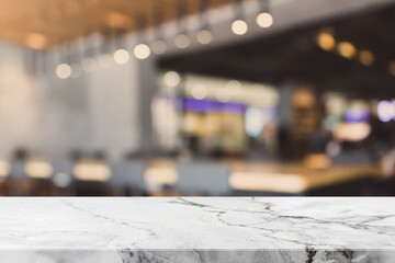 Stone table top and blurred bokeh cafe and coffee shop interior background with vintage filter - can used for display or montage your products.