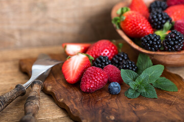 Berries on wooden cutting board