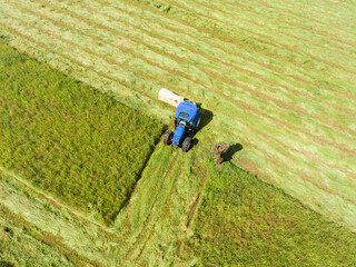 Tractor in a field - Cutting grass - Aerial photo