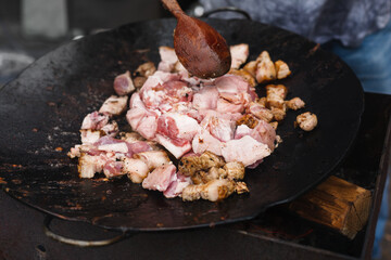 Bacon chop fried on grill in big frying pan
