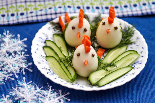 Funny chickens from eggs, baby food on the Christmas table with the symbol of 2017