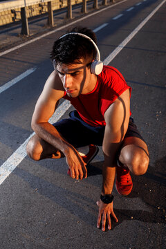 Portrait of young athlete man ready to have a good running start.