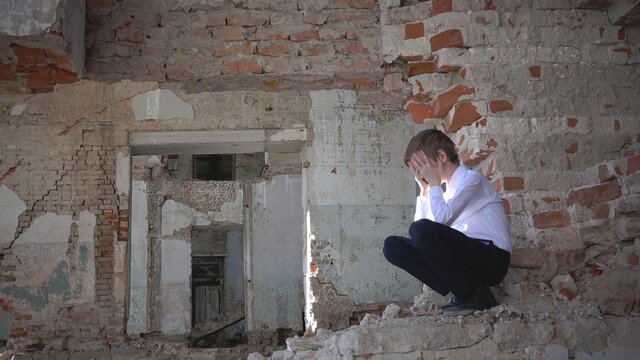 An orphan boy, sad and crying in a ruined building after the war, lost, fear, loneliness, history
