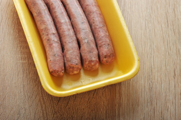 raw meat sausages kupaty in the yellow plastic tray