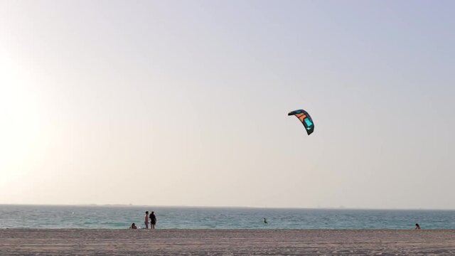 Kite-boarder jumps on the beach