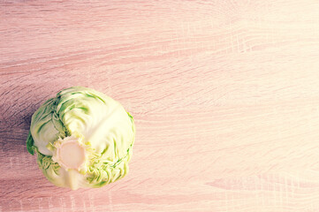 whole fresh green head of cabbage on wooden background