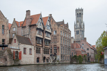 Fototapeta premium Old town of Bruges (Brugge) with brick houses above canal and famous Belfry on the background, Belgium