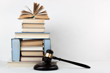Law concept open book with wooden judges gavel on table in a courtroom or law enforcement office,...
