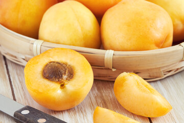 Naklejka na ściany i meble Fresh and ripe raw apricots on wooden background