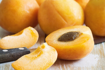 Naklejka na ściany i meble Fresh and ripe raw apricots on wooden background
