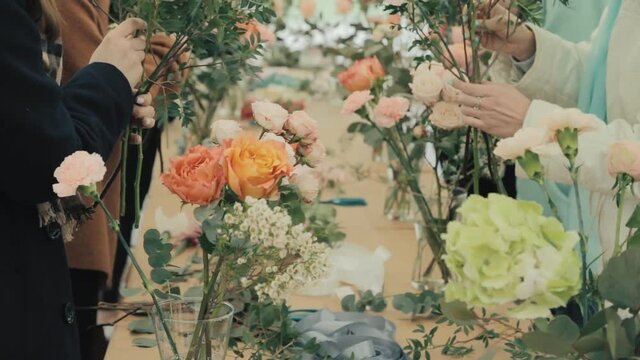 Many beautiful flowers in the bouquet, flower shop, florist girl works on the order, makes a festive bouquet for the customer, fresh flowers, a nice gift for your favorite woman on Mother's Day.