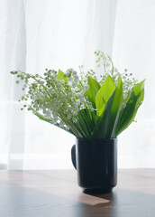 Lilies of the valley. Bouquet on the table.
