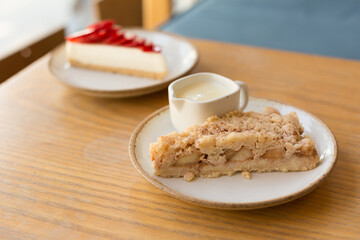 Apple Crumble Pie and Strawberry Cheesecake on Wooden Table
