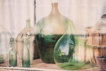 Old empty wine bottles behind the glass