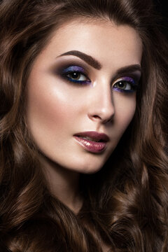 Beautiful girl with perfect skin, colorful make-up, evening hairstyle. .Beauty face. Picture taken in the studio.