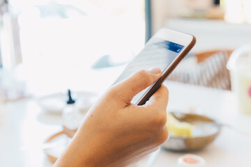 Smartphone on women hand in cafe