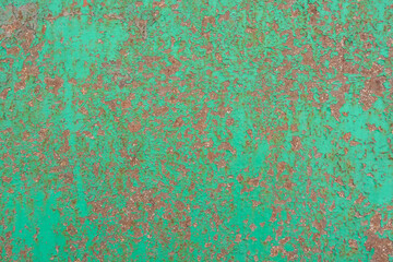 Green cracked painting on metal surface