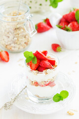 Dessert in a glass with granola, yogurt and strawberries. Useful breakfast.