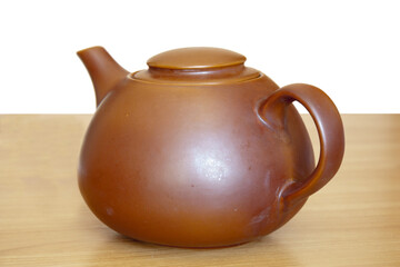 Brown ceramic teapot on a wooden table