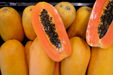 Slice of sweet papaya on papaya pile.