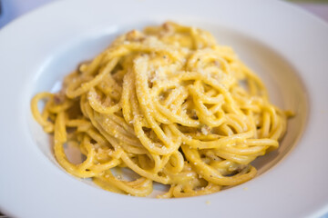 Spaghetti Carbonara served on white plate. Soft Focus.