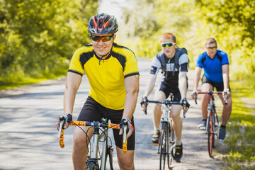 bikers on a summer workout on a forest road