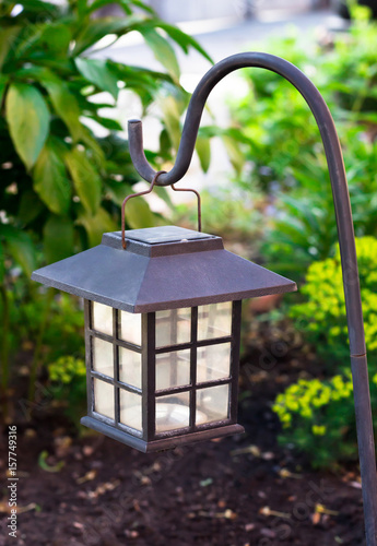 "Garden lighting - lights on the solar battery on a green lawn" Stock