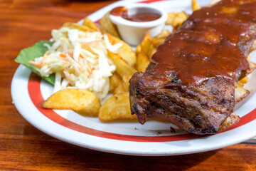 Grilled steak - Grilled meat ribs on the plate with hot sauce