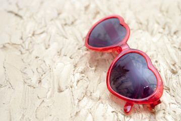 Summer holiday background of sunglasses on a golden background