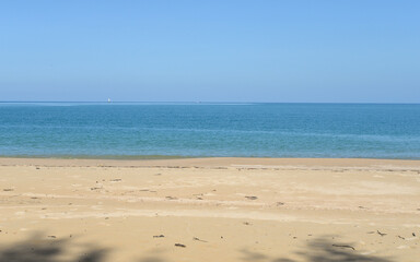 Fototapeta na wymiar Peaceful sand beach and blue sky, natural background in Thailand
