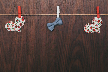 Background, a heart hanging on a rope on a wooden background