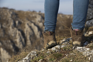 Hiking boot closeup on mountain rocks