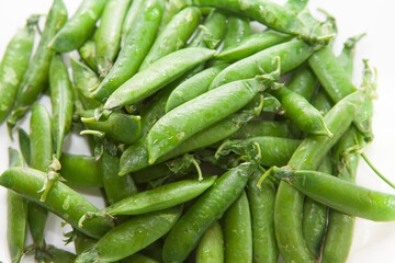 Green peas, close-up on a white background, plate