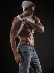 Fototapeta na wymiar portrait of strong Athletic Fitness man over black background