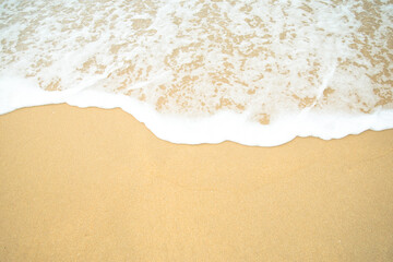 Fototapeta na wymiar Sand beach and white sea water