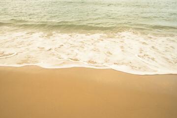 Fototapeta na wymiar Sand beach and white sea water with sunlight reflect