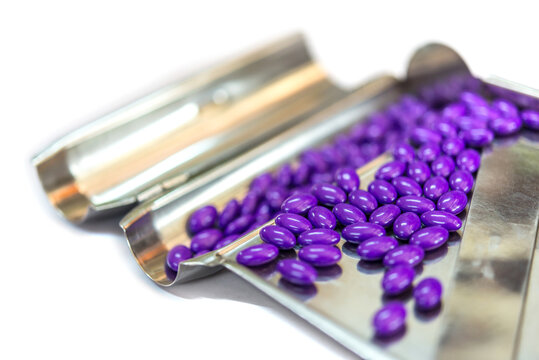 Violet pills on stainless steel counting tray