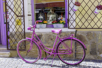 Retro style purple bicycle near the store.